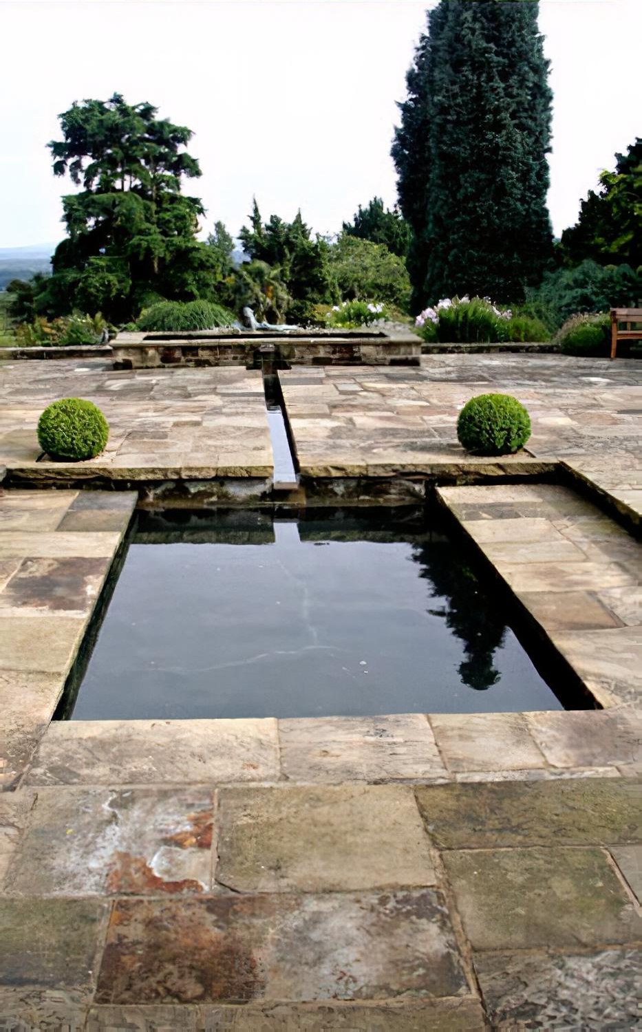 Water garden with reflective pool & rill by Hampshire garden designer